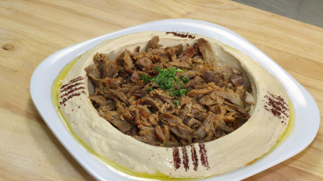 Hummus with Pita Bread Topped with Steak
