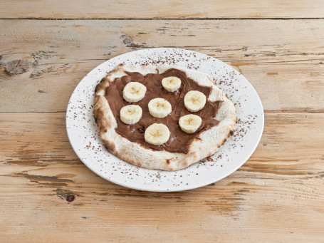 Vegan Sweet Pizza With Chocolate Spread, Pineapple, Hazelnuts And Icing Sugar