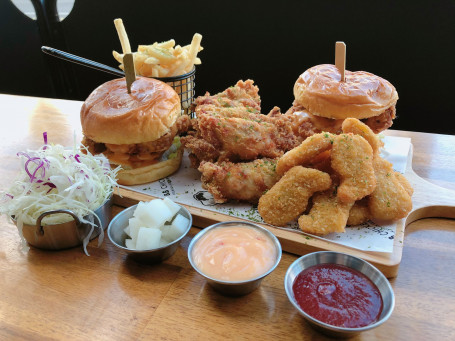 2 People Sharing Meals With Spicy Burgers