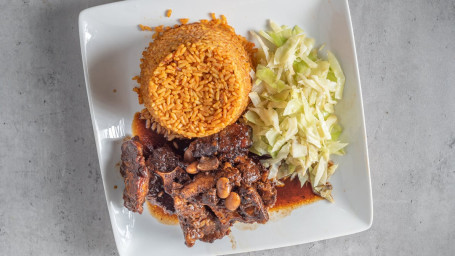 Jolof Rice With Oxtail Served With Cabbage